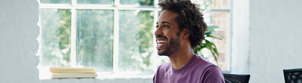 Male consuming media on their TV which Nielsen's media planning tools help measure.